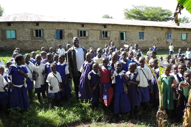 Pupils stand together outside their school in Kakichuma