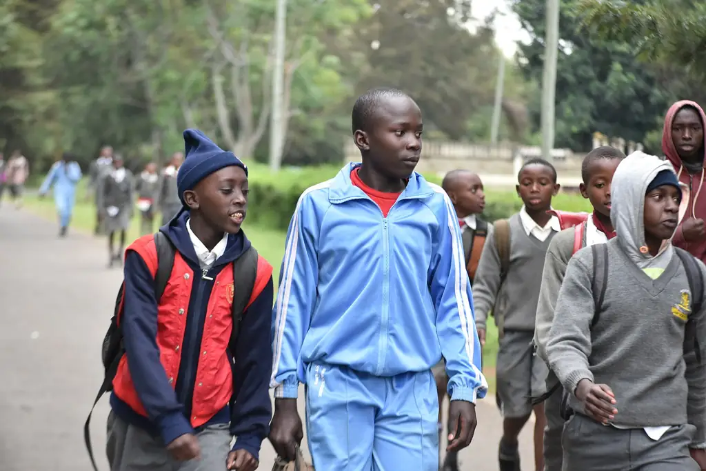 Pupils in school uniform walking home together after class in Kenya